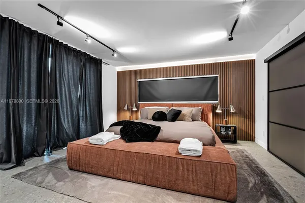 a spacious bedroom with a bed and window