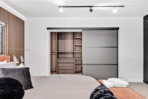 a bedroom with a bed couch and window