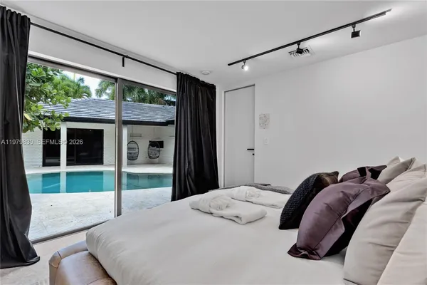 a room with gym equipment and large windows