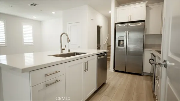 a kitchen with refrigerator a sink and cabinets