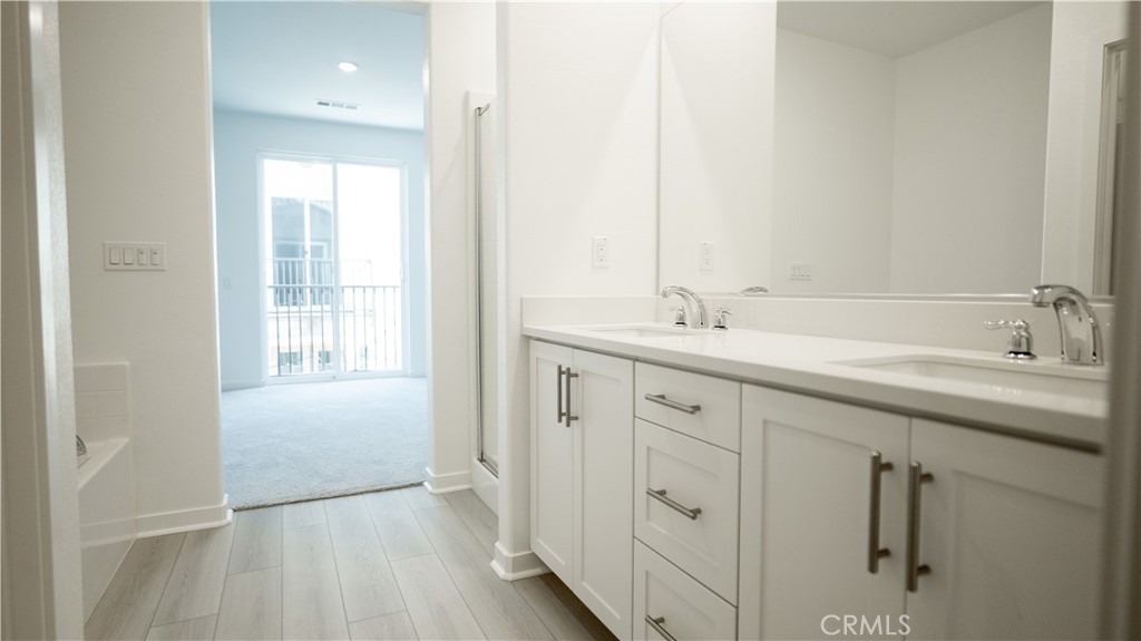 8457 Gabrielino Court Rancho Cucamonga, CA 91730 - Photo 16 of 58 a spacious bathroom with a double vanity sink a mirror and a shower