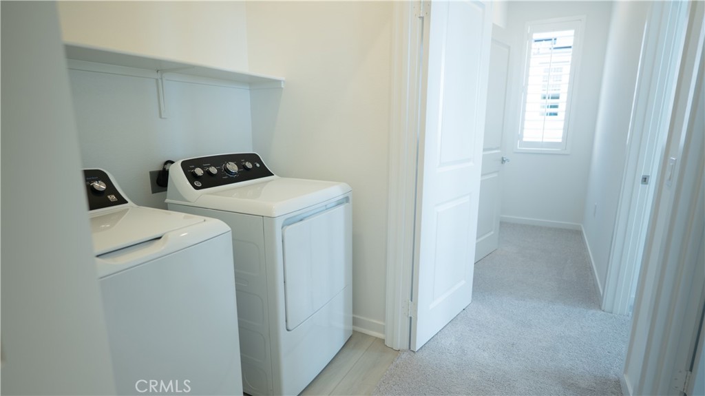 8457 Gabrielino Court Rancho Cucamonga, CA 91730 - Photo 19 of 58 a utility room with dryer and washer