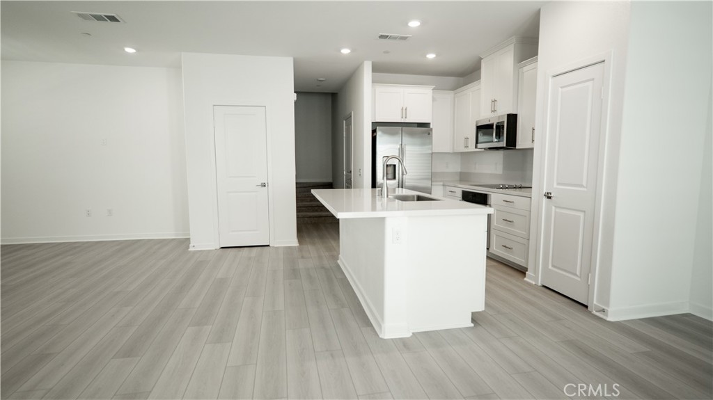 8457 Gabrielino Court Rancho Cucamonga, CA 91730 - Photo 21 of 58 a kitchen with stainless steel appliances a refrigerator sink and microwave