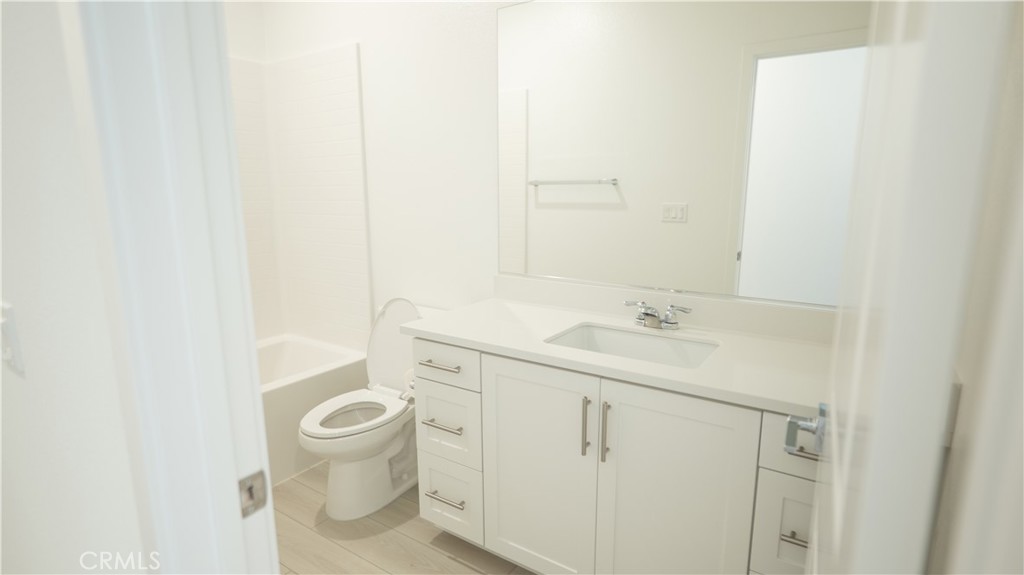 8457 Gabrielino Court Rancho Cucamonga, CA 91730 - Photo 24 of 58 a bathroom with a sink a toilet and a mirror