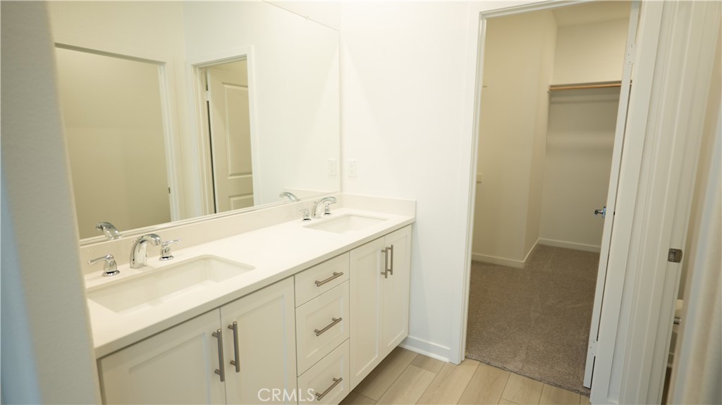 8457 Gabrielino Court Rancho Cucamonga, CA 91730 - Photo 30 of 58 a spacious bathroom with a double vanity sink and mirror