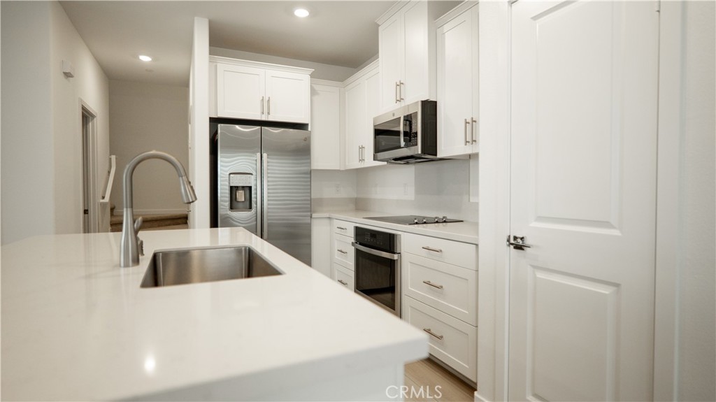 8457 Gabrielino Court Rancho Cucamonga, CA 91730 - Photo 3 of 58 a kitchen with stainless steel appliances granite countertop a sink stove and refrigerator