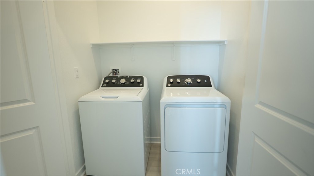 8457 Gabrielino Court Rancho Cucamonga, CA 91730 - Photo 31 of 58 a utility room with dryer and washer
