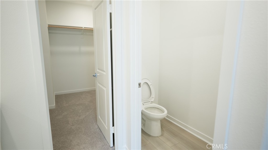 8457 Gabrielino Court Rancho Cucamonga, CA 91730 - Photo 34 of 58 a white toilet sitting next to a shower