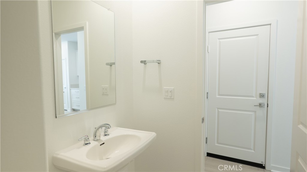 8457 Gabrielino Court Rancho Cucamonga, CA 91730 - Photo 44 of 58 a bathroom with a sink a toilet and a mirror