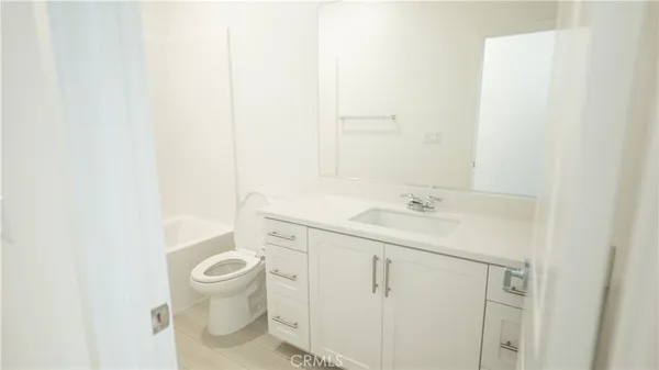 a spacious bathroom with a shower sink and a mirror