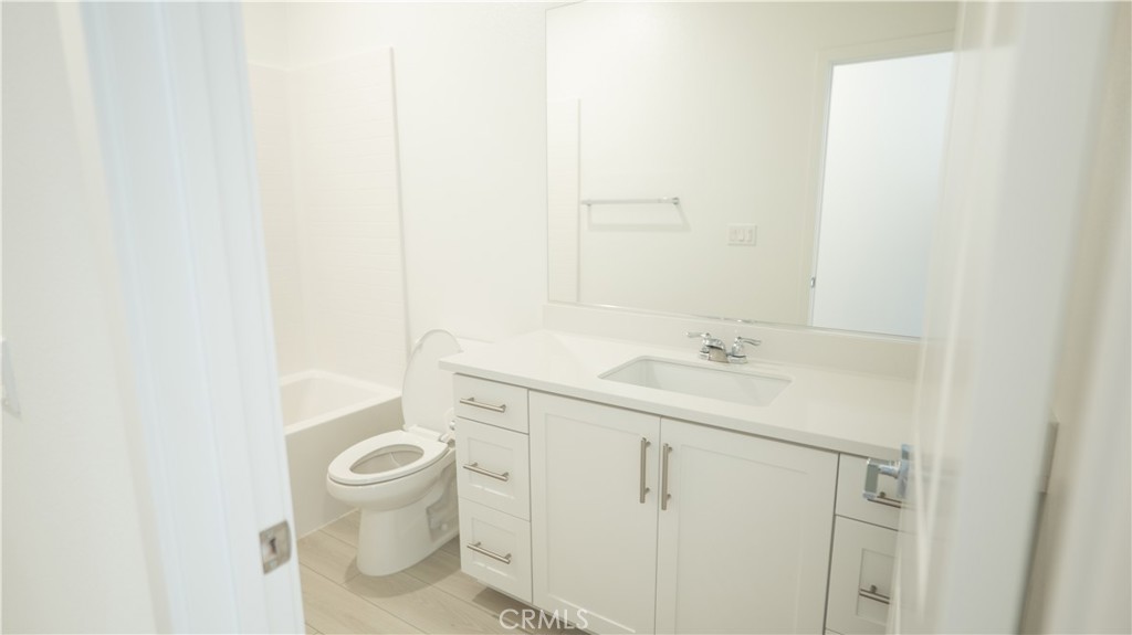 8457 Gabrielino Court Rancho Cucamonga, CA 91730 - Photo 48 of 58 a bathroom with a sink a toilet and a mirror