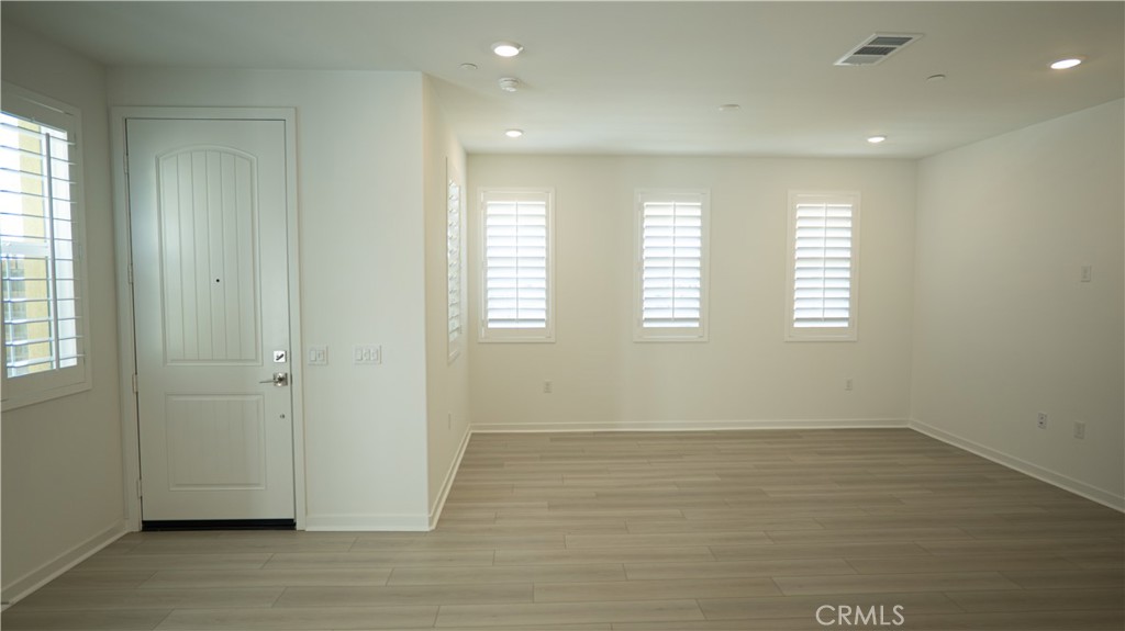 8457 Gabrielino Court Rancho Cucamonga, CA 91730 - Photo 51 of 58 a view of an empty room with wooden floor and a window