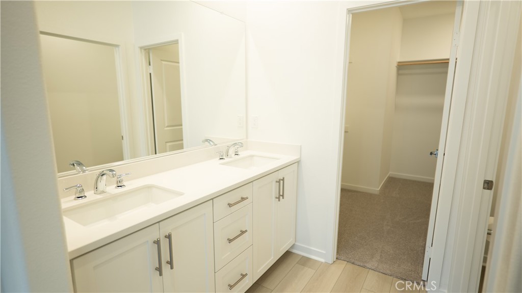 8457 Gabrielino Court Rancho Cucamonga, CA 91730 - Photo 55 of 58 a spacious bathroom with a shower sink and a mirror