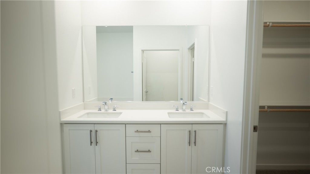 8457 Gabrielino Court Rancho Cucamonga, CA 91730 - Photo 57 of 58 a bathroom with a sink and a mirror