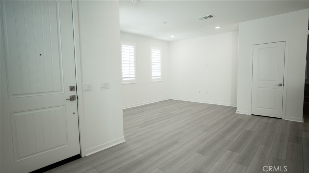 8457 Gabrielino Court Rancho Cucamonga, CA 91730 - Photo 6 of 58 wooden floor in an empty room with a window