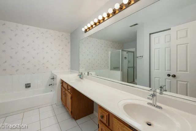 a bathroom with a tub sink and mirror