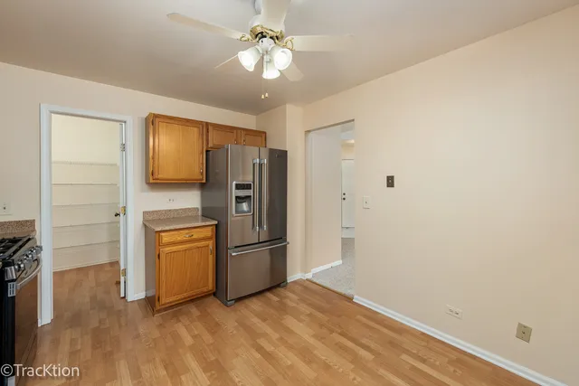 a view of a refrigerator in kitchen and wooden floor