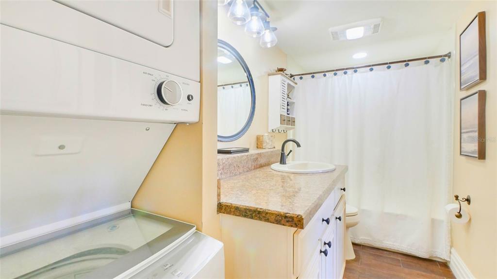 7150 Sunset Way, Unit 903E St. Pete Beach, FL 33706 - Photo 14 of 26 a bathroom with a sink and a mirror