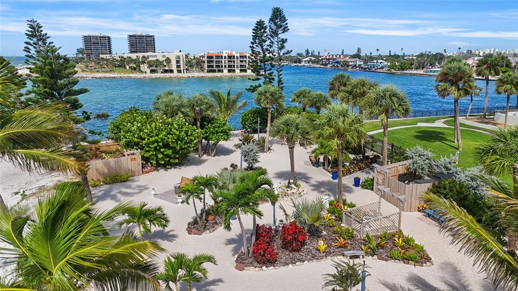 7150 Sunset Way, Unit 903E St. Pete Beach, FL 33706 - Photo 15 of 26 a view of a lake with a building in the background