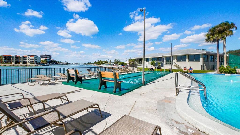 7150 Sunset Way, Unit 903E St. Pete Beach, FL 33706 - Photo 18 of 26 a view of a patio with chairs and a table