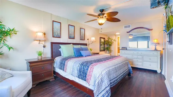 a bedroom with a bed and a chandelier