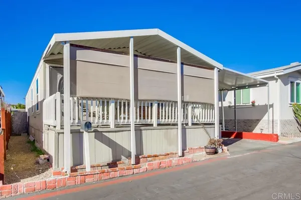 a view of small house with wooden floor and fence