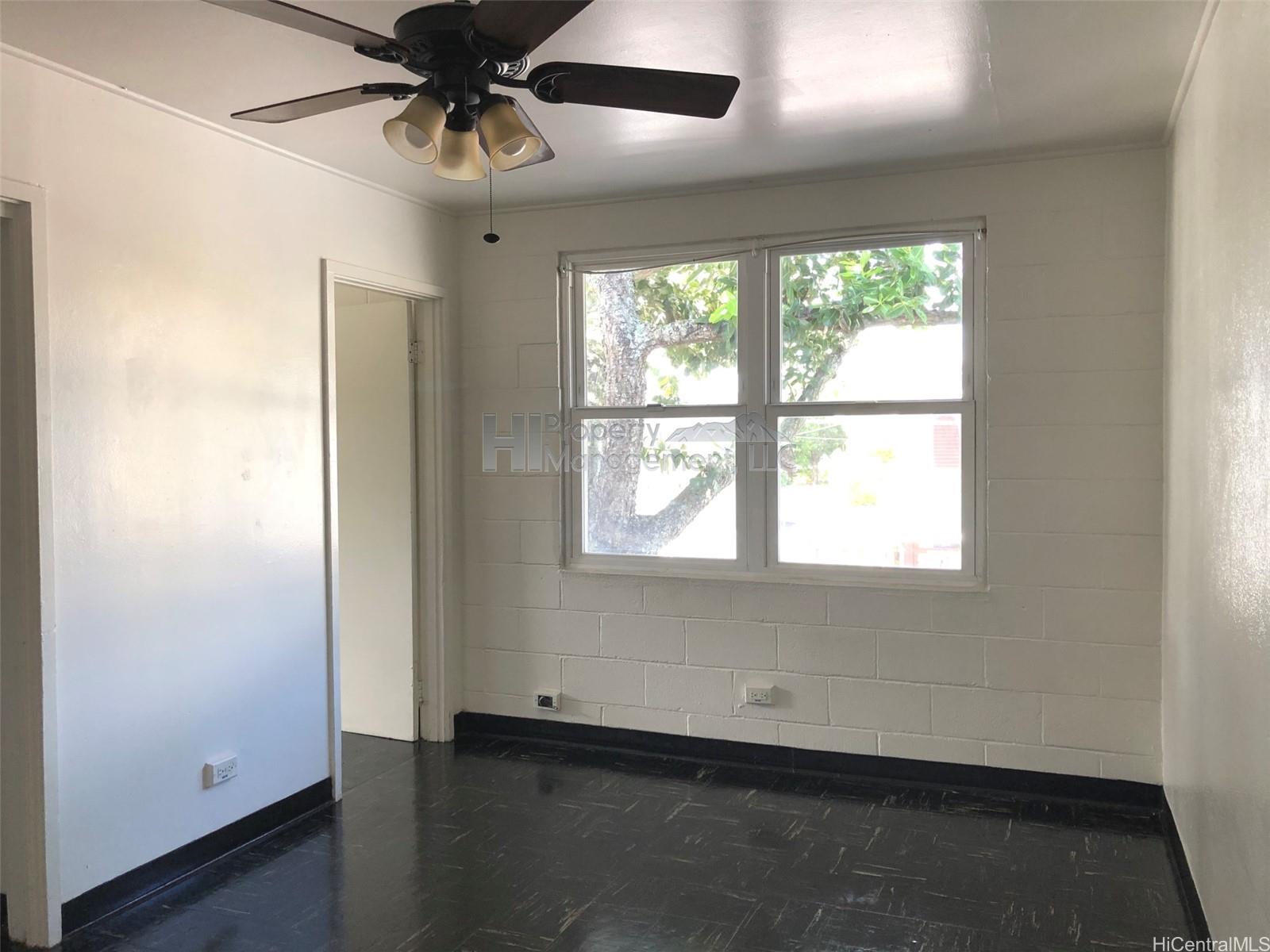 656 Kailua Road, Unit 1 Kailua, HI 96734 - Photo 1 of 1 an empty room with a window and a ceiling fan