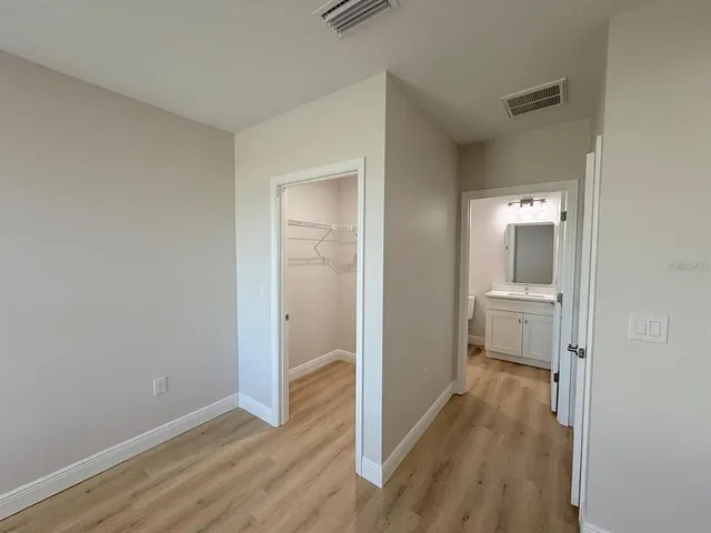 a view of a room with wooden floor