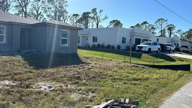 a view of a garden with a house