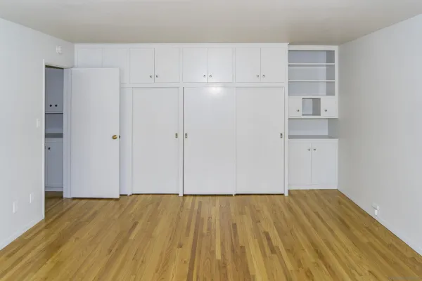a view of walk in closet with wooden floor