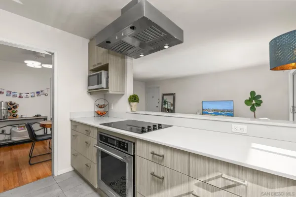 a kitchen with stainless steel appliances granite countertop a sink and stove top oven