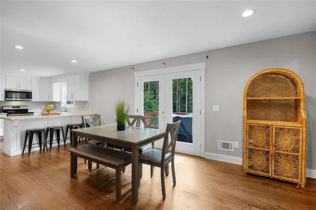 a view of a dining room with furniture and wooden floor