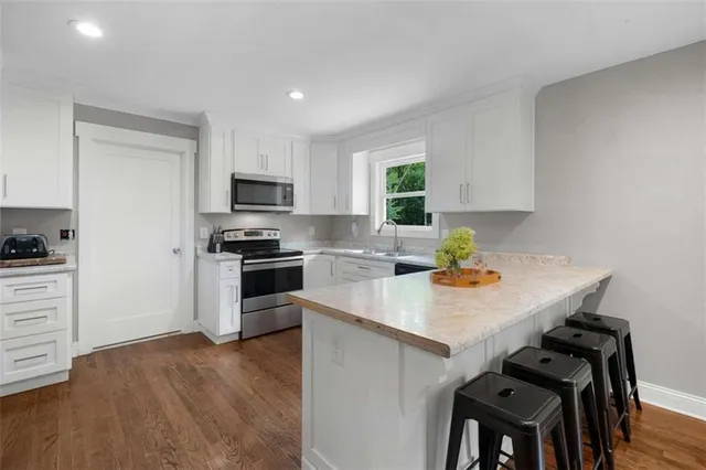 a kitchen with a stove a sink and a refrigerator