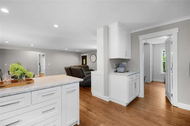 a kitchen with white cabinets and a sink