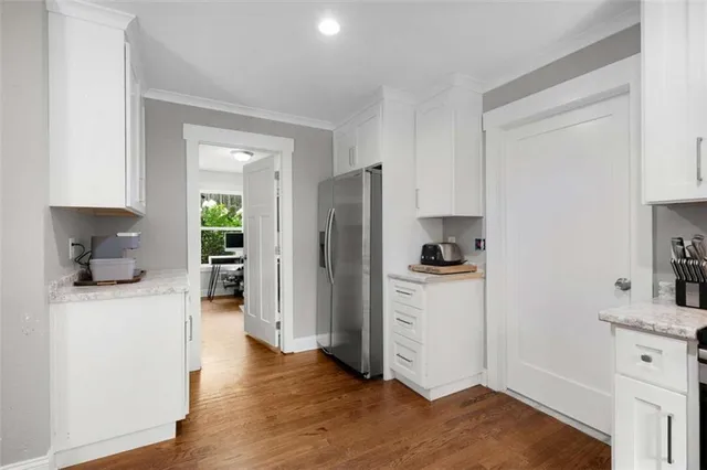 a kitchen with a refrigerator and a stove top oven