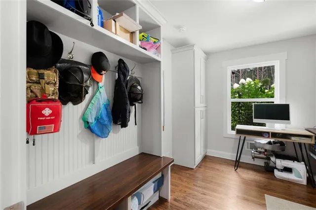a view of a room with wooden floor and a window