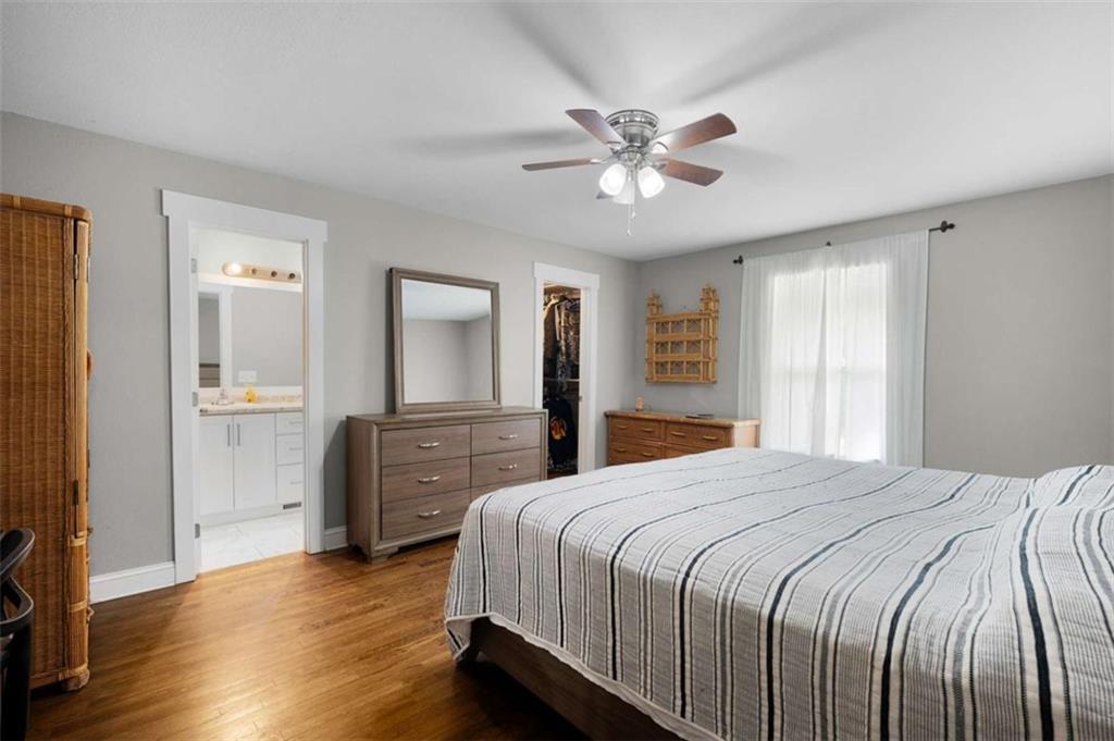 191 Hightower Loop Road Ranger, GA 30734 - Photo 21 of 27 a bedroom with a bed and a chandelier