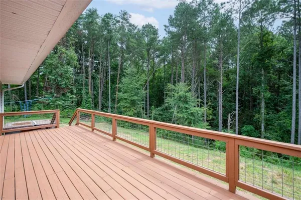 a view of backyard with deck and trees