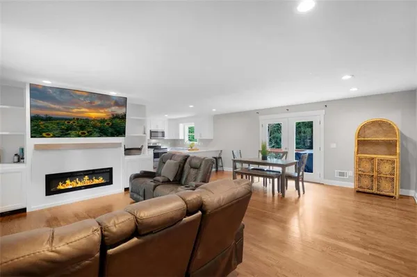 a living room with fireplace furniture and a flat screen tv