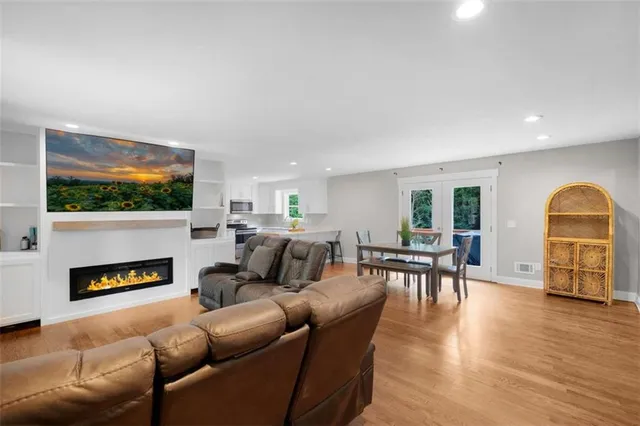 a living room with fireplace furniture and a flat screen tv