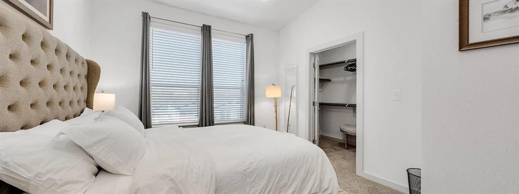 10030 Garland Road, Unit 1401 Dallas, TX 75218 - Photo 5 of 16 a bedroom with a bed and a window
