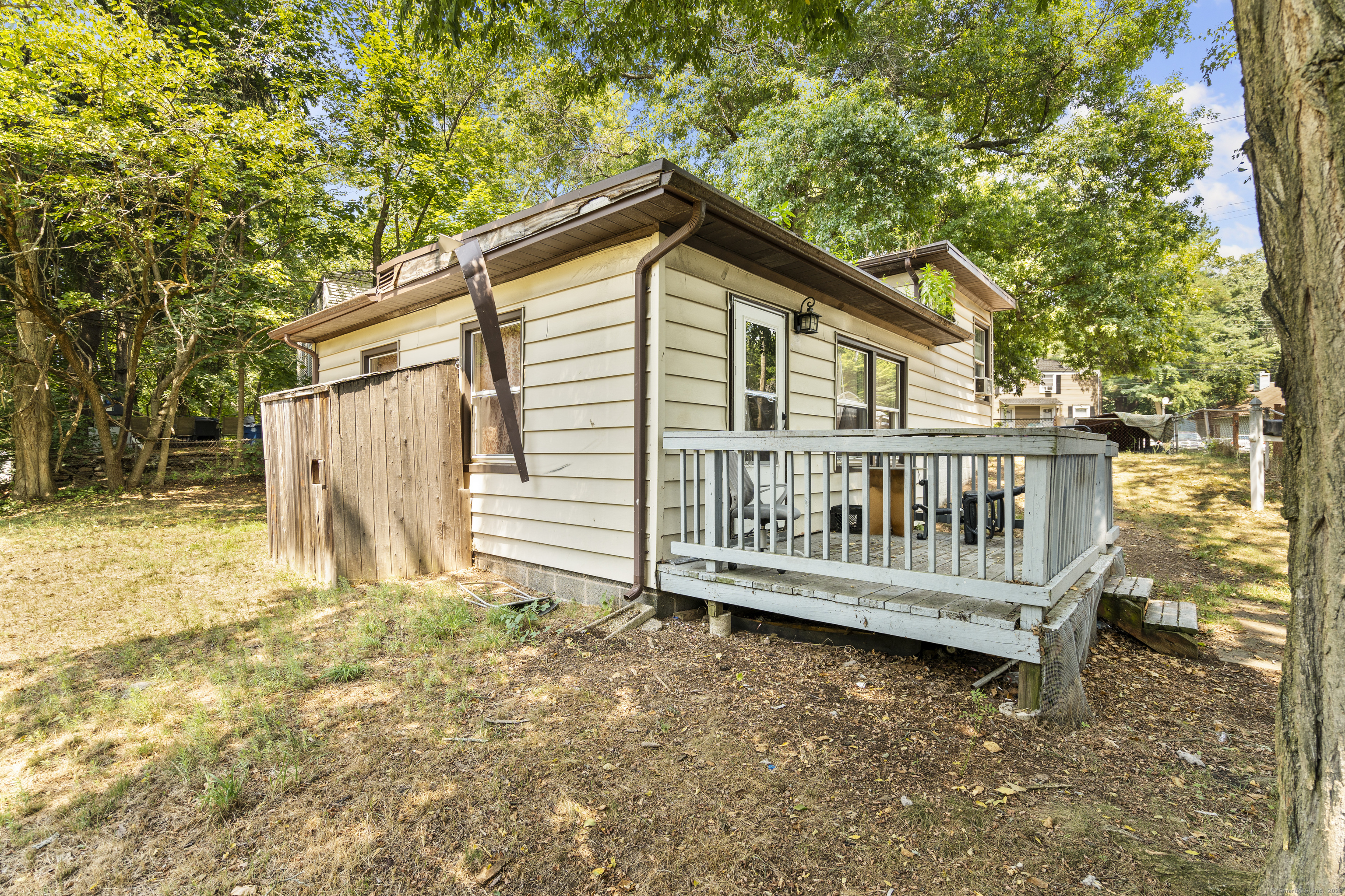 a view of a wooden house with a small yard