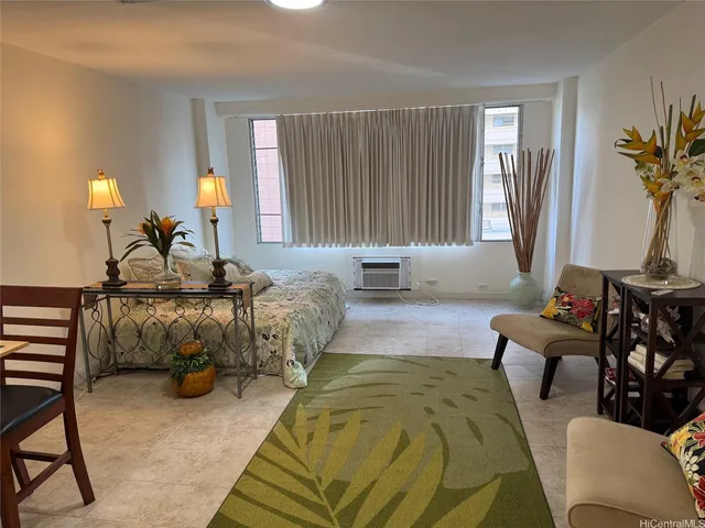 a bedroom with furniture and a large window