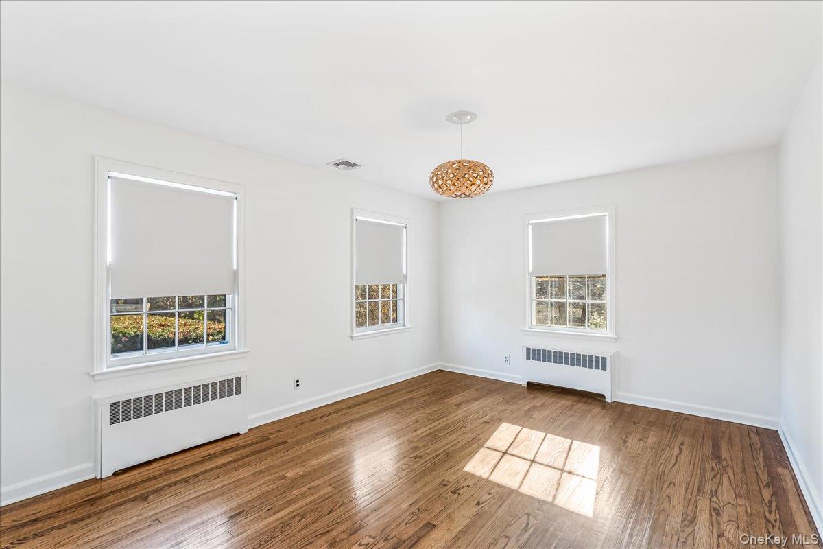 110 Hegemans Lane Glen Head, NY 11545 - Photo 15 of 26 a view of an empty room with wooden floor and a window