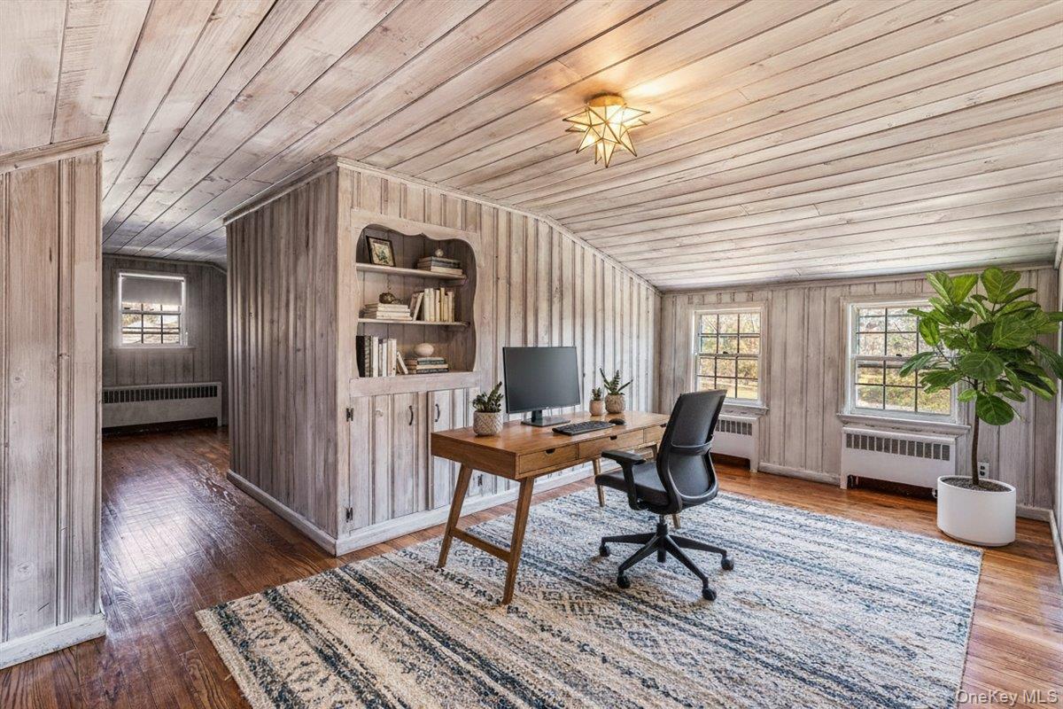 110 Hegemans Lane Glen Head, NY 11545 - Photo 17 of 26 a work room with furniture and wooden floor