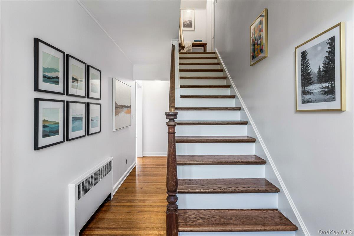 110 Hegemans Lane Glen Head, NY 11545 - Photo 3 of 26 a view of staircase with lots of frames on wall and a view of a staircase