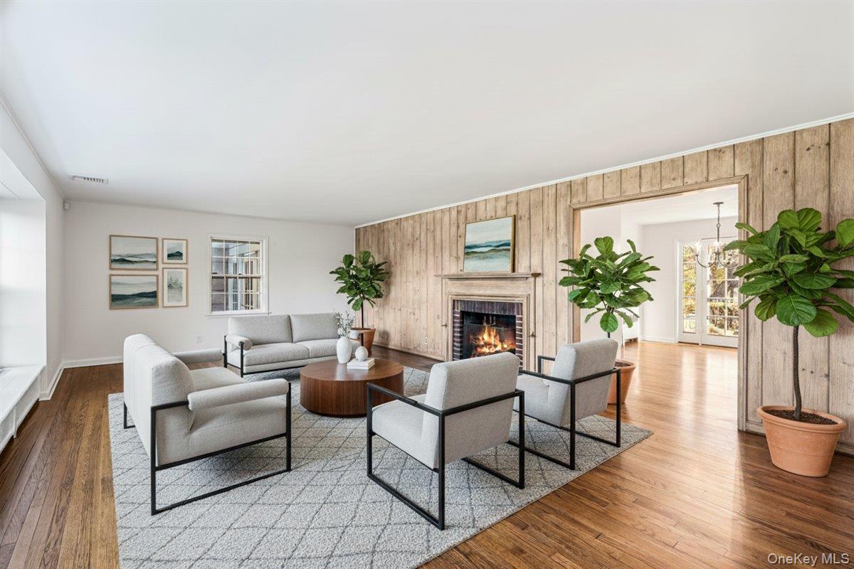 110 Hegemans Lane Glen Head, NY 11545 - Photo 4 of 26 a living room with furniture a fireplace and a potted plant