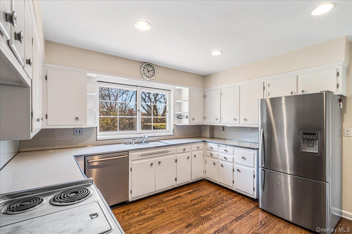 110 Hegemans Lane Glen Head, NY 11545 - Photo 9 of 26 a kitchen with a sink a refrigerator and window