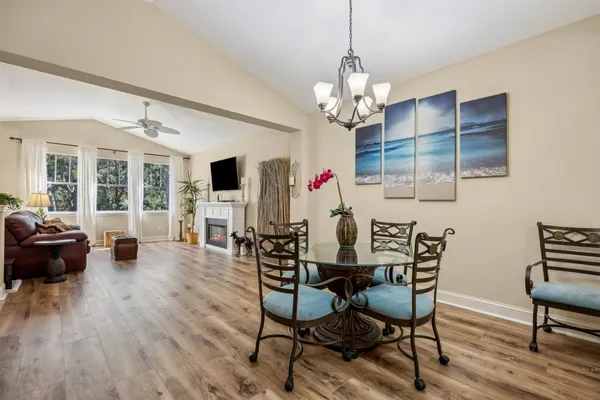 a view of a dining room with furniture wooden floor and chandelier