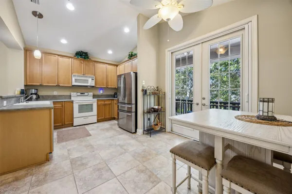 a kitchen with stainless steel appliances granite countertop a stove refrigerator sink and cabinets